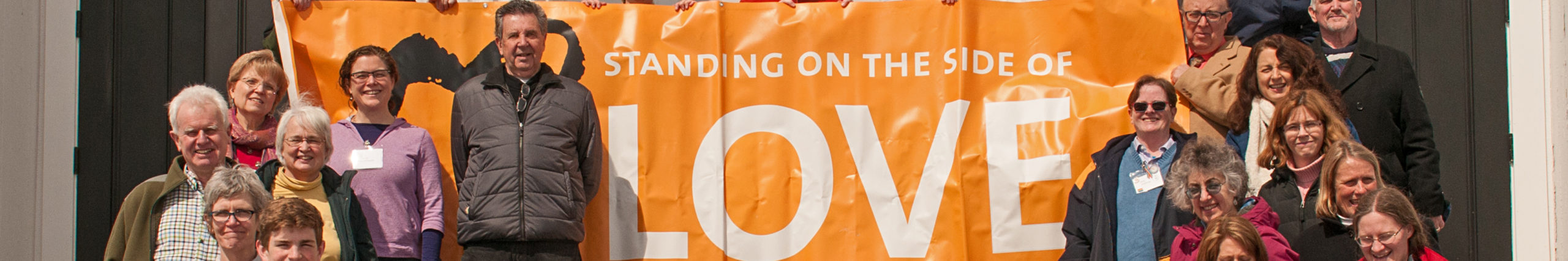 Siding With Love Banner on steps of church